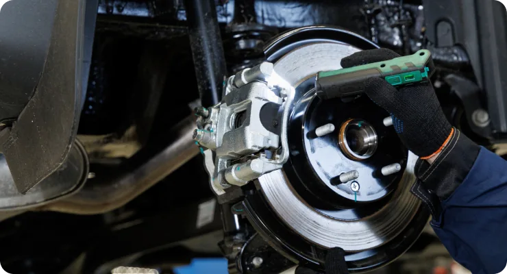 A detailed shot of a car's wheel hub and brake rotor, ready for brake repair or replacement.