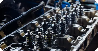 A detailed shot of an exposed car engine with various components, ready for repair or service.