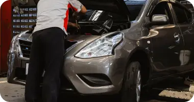 A close-up of a car's suspension or undercarriage, indicating a preventative maintenance inspection.