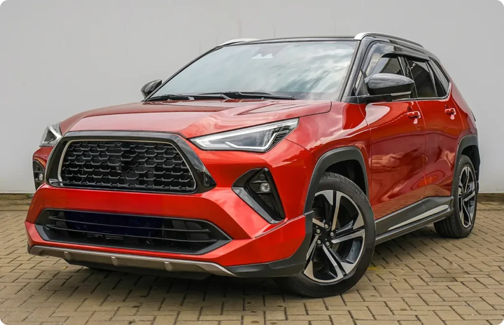 Asian auto repair in Stratford, PE by Wendell Taylor's Garage. A full, frontal view of a bright orange-red modern crossover SUV parked against a light background.