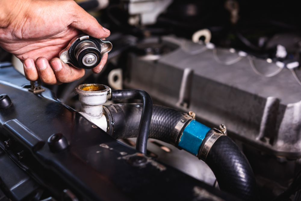Cooling System Repair in Stratford, PE At Wendell Taylor's Garage. Mechanic removing a radiator cap during a cooling system inspection in Stratford, PE.